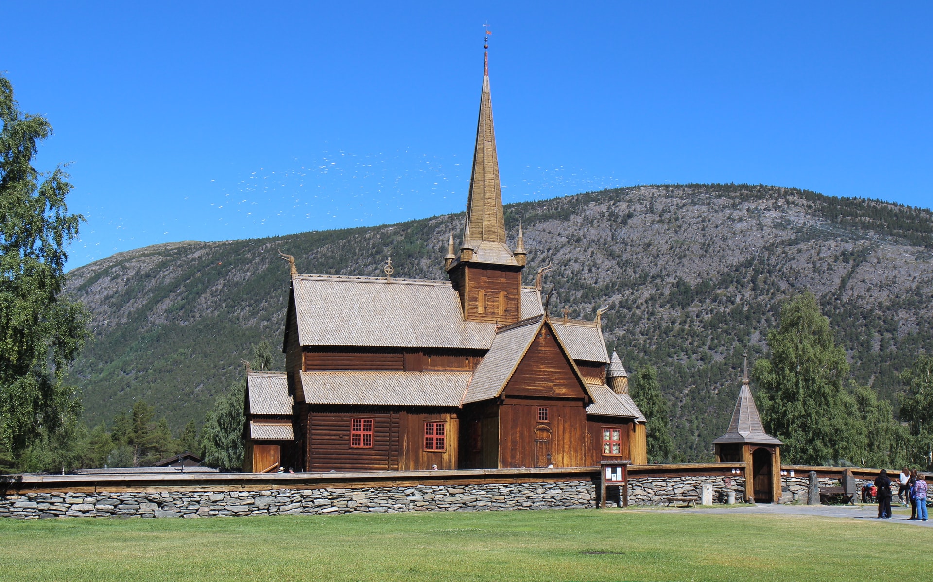 Sunny daytime image of 11th century Lom stave church in Norway shown as example of wood building endurance