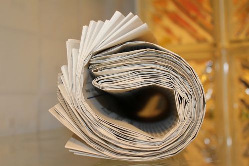 End view of rolled up newspaper as demonstration of wood product diversity