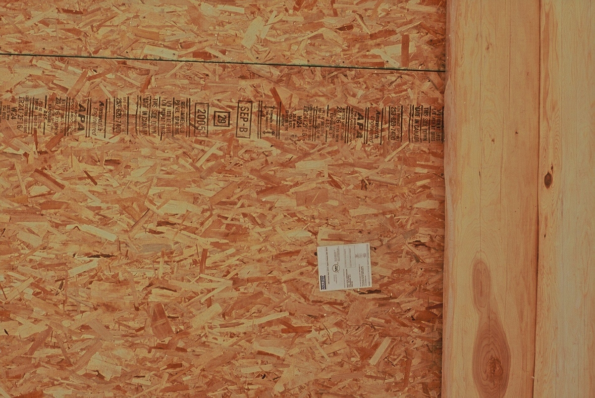 Close up view of Oriented strand board (OSB), a widely used, versatile engineered wood panel made using waterproof heat-cured adhesives