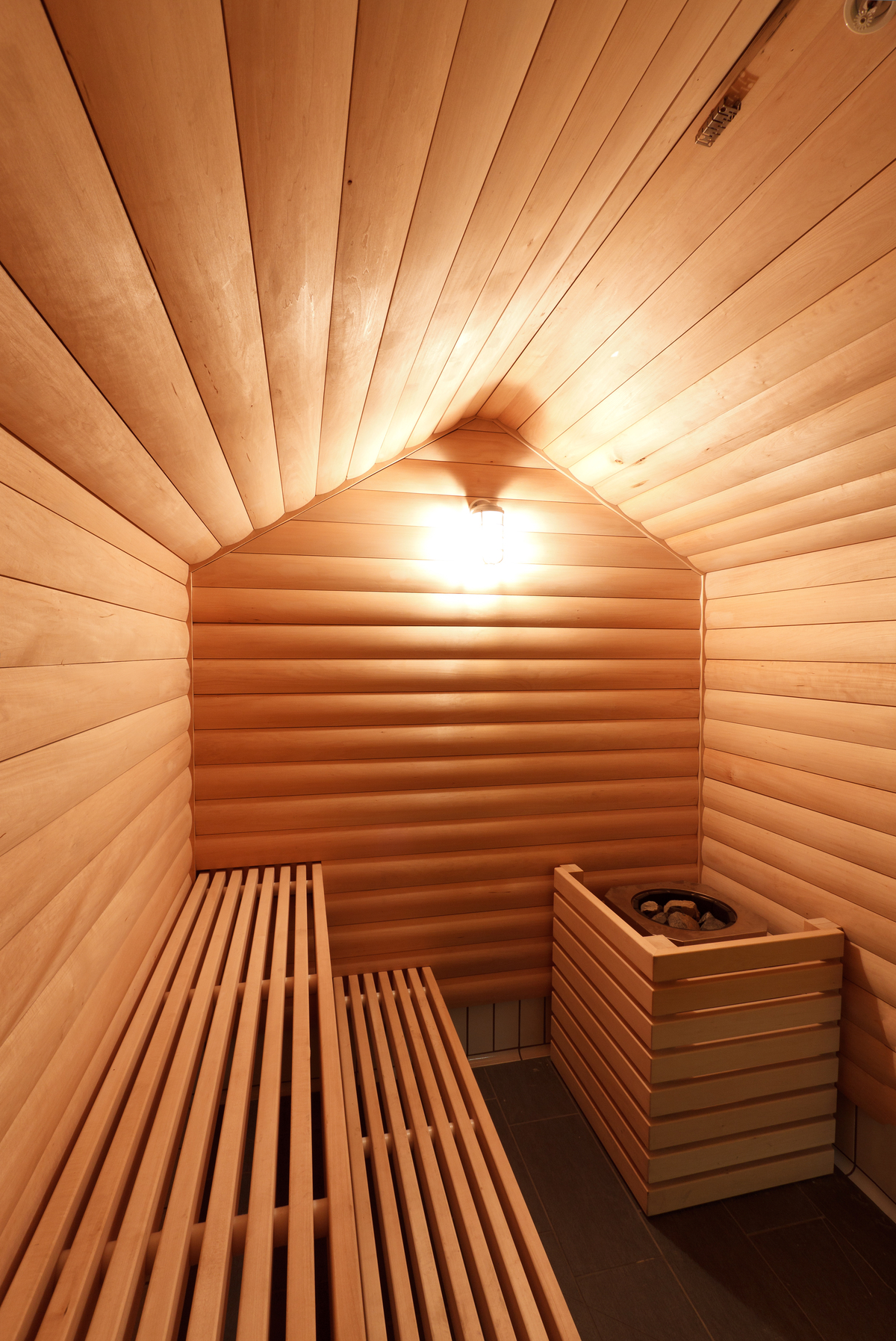 Interior view of Penticton Community Centre Sauna, showing wood paneling, wood seats, wood ceiling, and wood trim