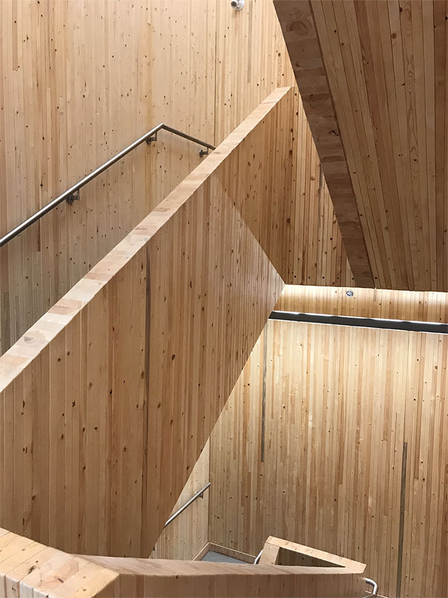 Prince George Fire Hall No. 1 stairwell featuring nail-laminated timber (NLT) panel railings and walls.