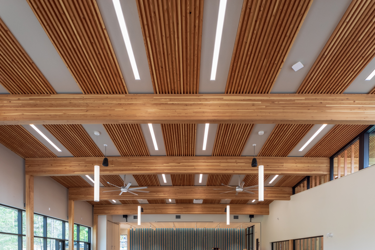 Interior ceiling view of Radium Hot Springs Community Hall showing mass timber construction including dowel-laminated timber (DLT) exposed roof members and glue-laminated timber (Glulam) timbers