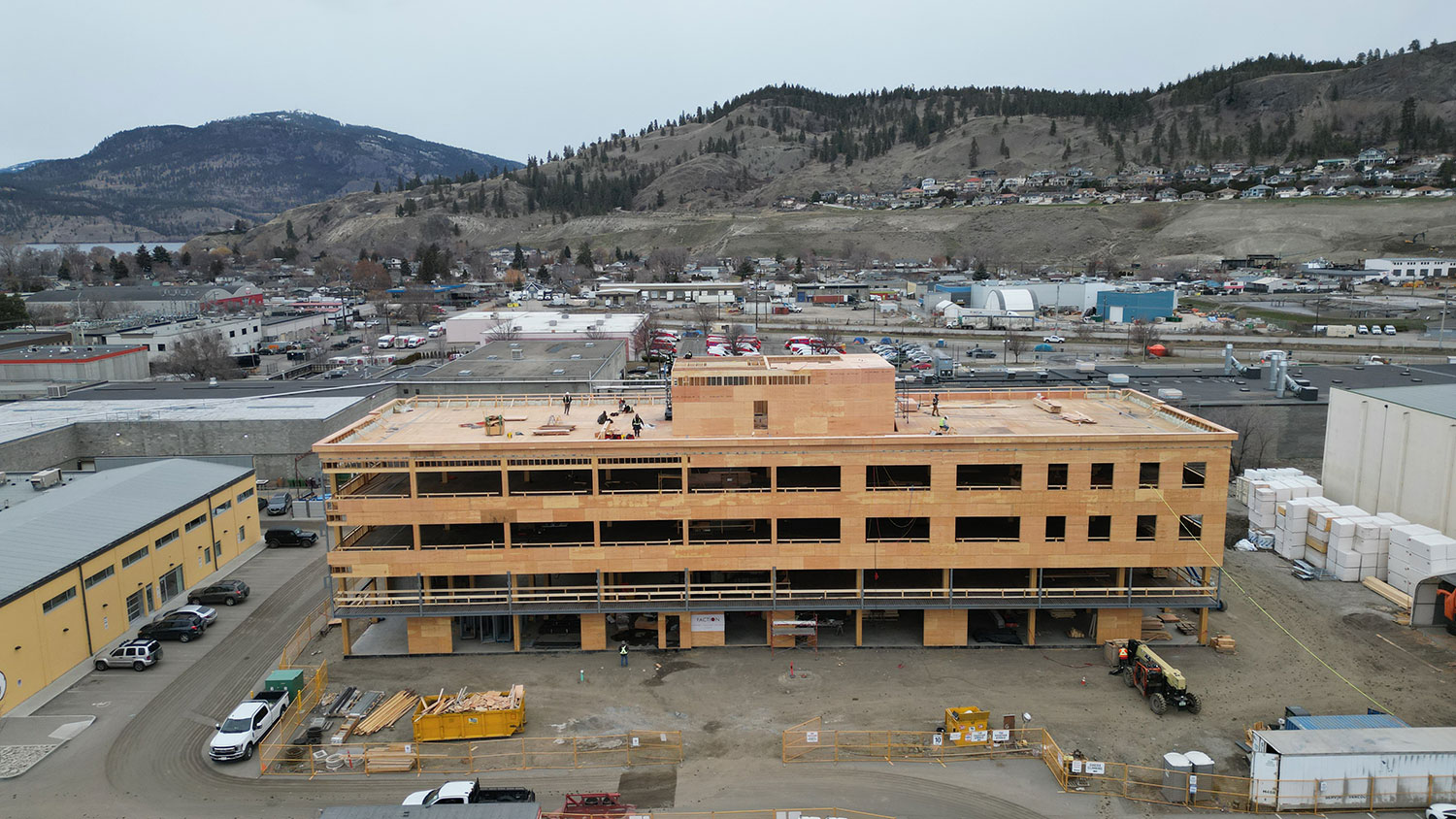 Aerial view of The Exchange during construction. Walls and roof are being built, surrounding the NLT panel ceilings and glulam beams and columns.